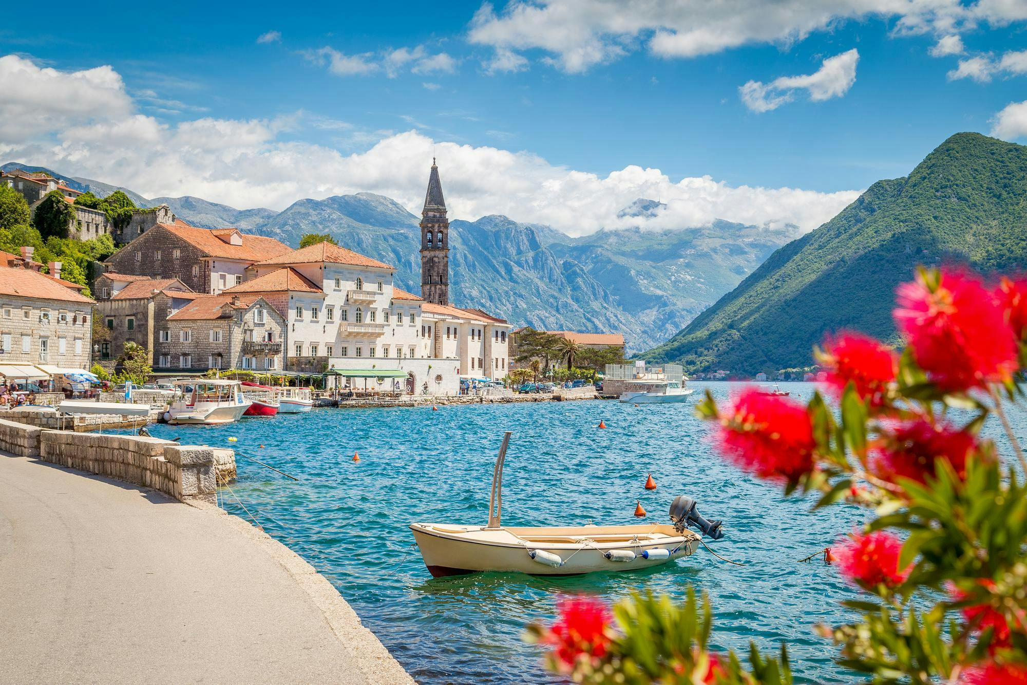 Scenic panorama view of the historic town of Perast at famous Bay of Kotor with blooming flowers on a beautiful sunny day with blue sky and clouds in summer, Montenegro, southern Europe

Shutterstock