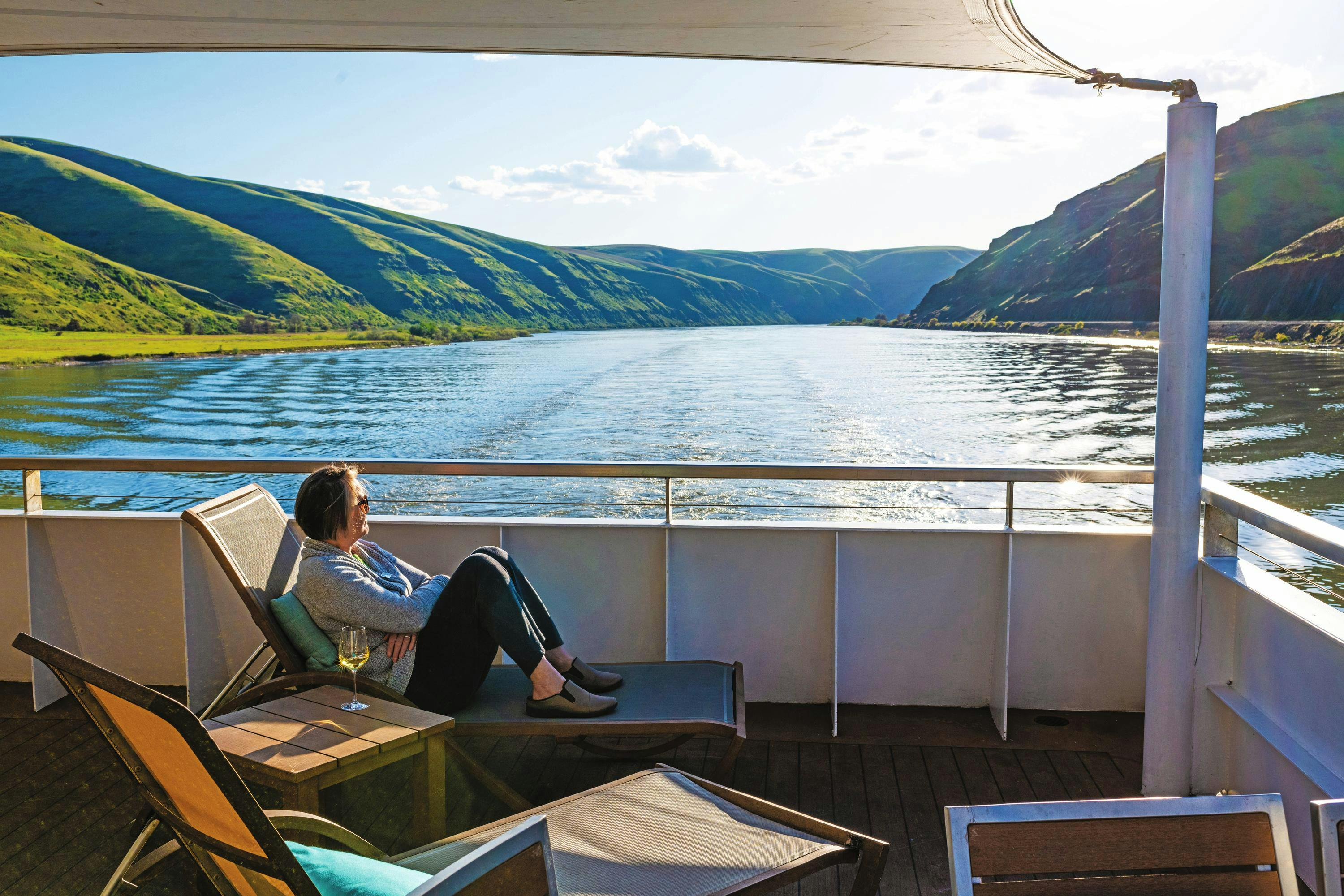 Guest enjoying the sun deck views of Columbia Snake River on the ship National Geographic Quest/Venture