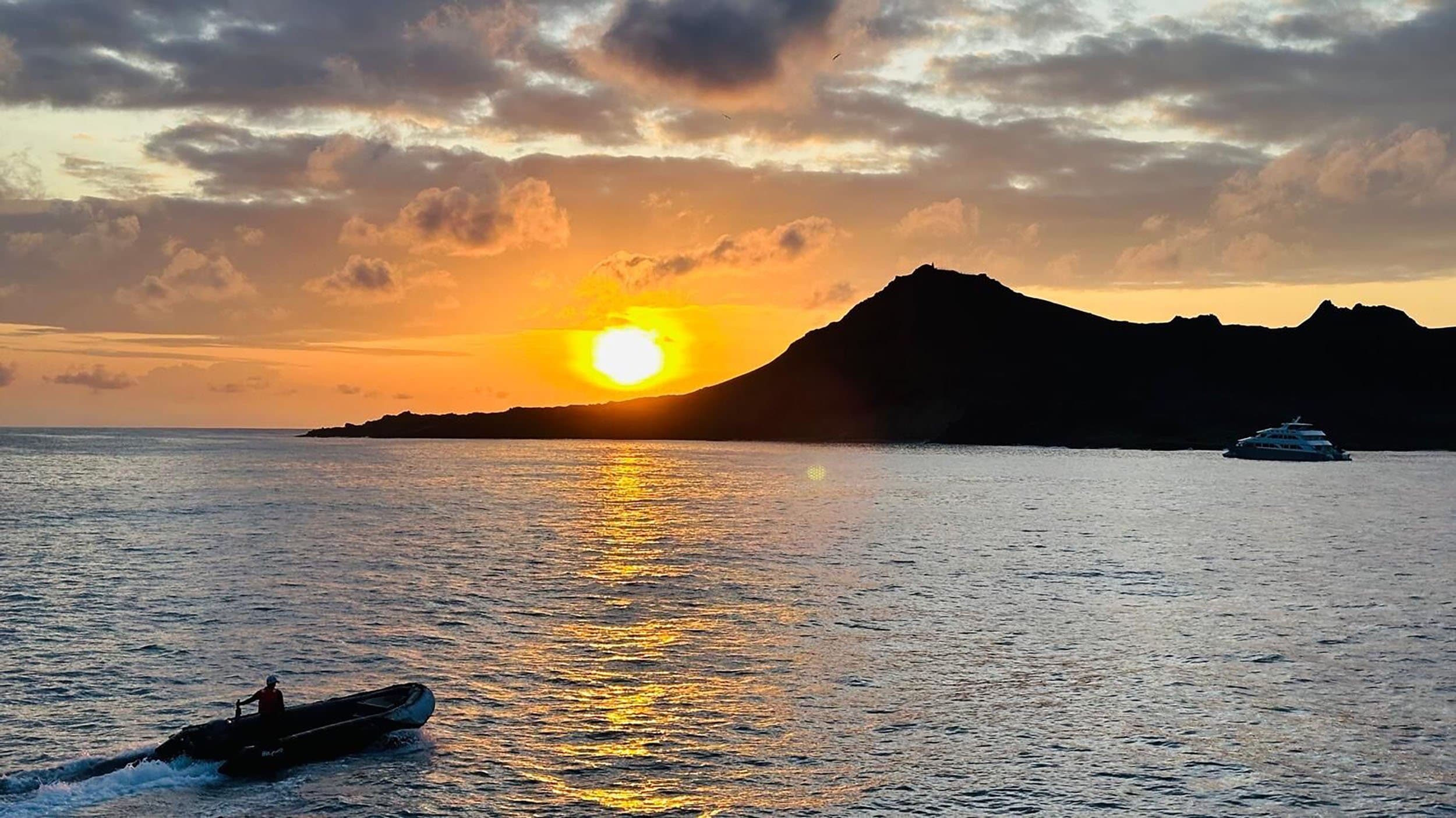 a zodiac at sunset